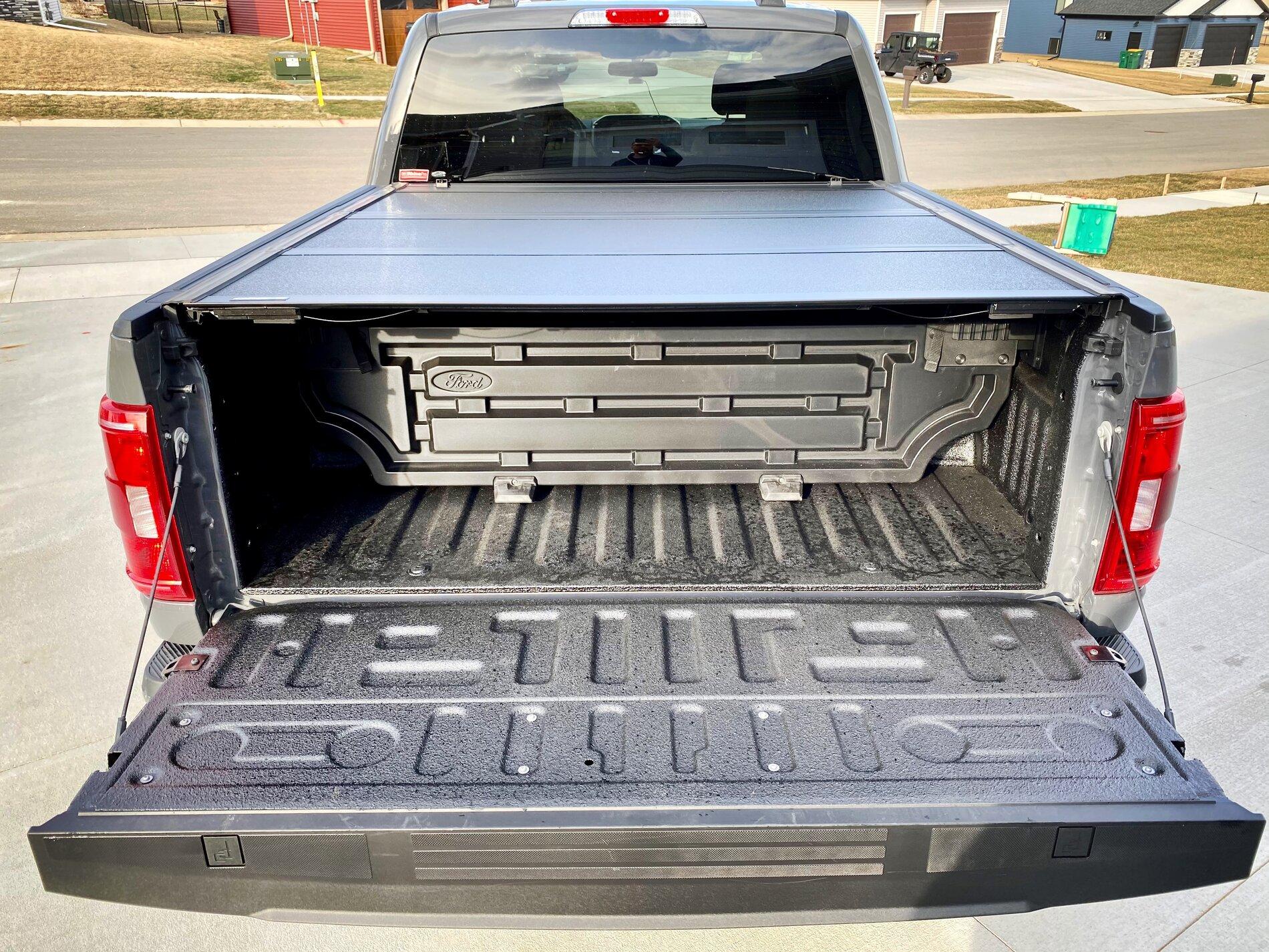 Ford F-150 Lightning Finally got my bed setup: bed liner, tonneau cover, and bed divider. 83D78BA0-317D-465E-B62D-21A691FF0799