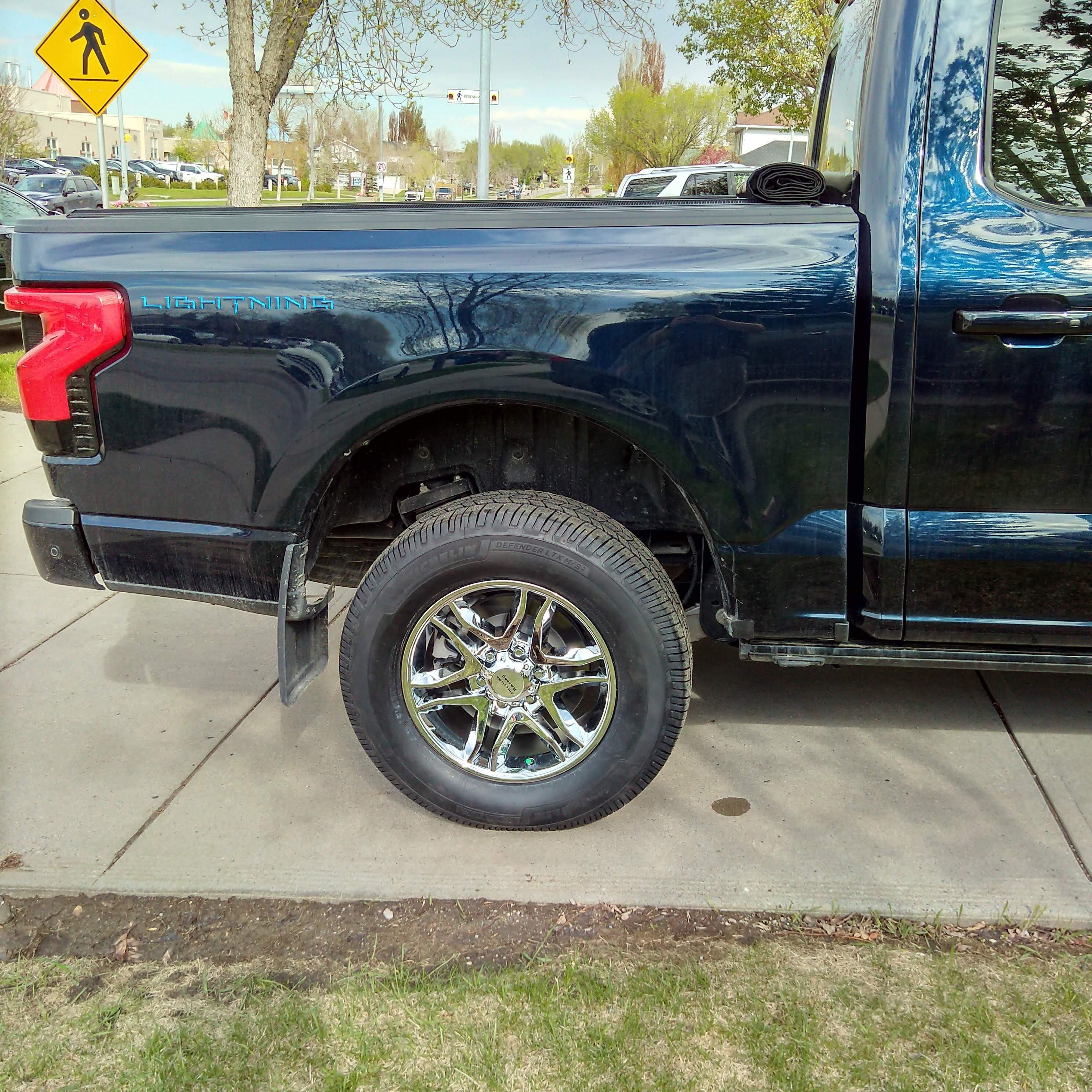 Ford F-150 Lightning Added some Old School Bling to my Lightning: 18" X 8.5" American Racing AR893 wheels, McGard Lug nuts and Michelin Defender 2 tires IMG_20240524_1722559